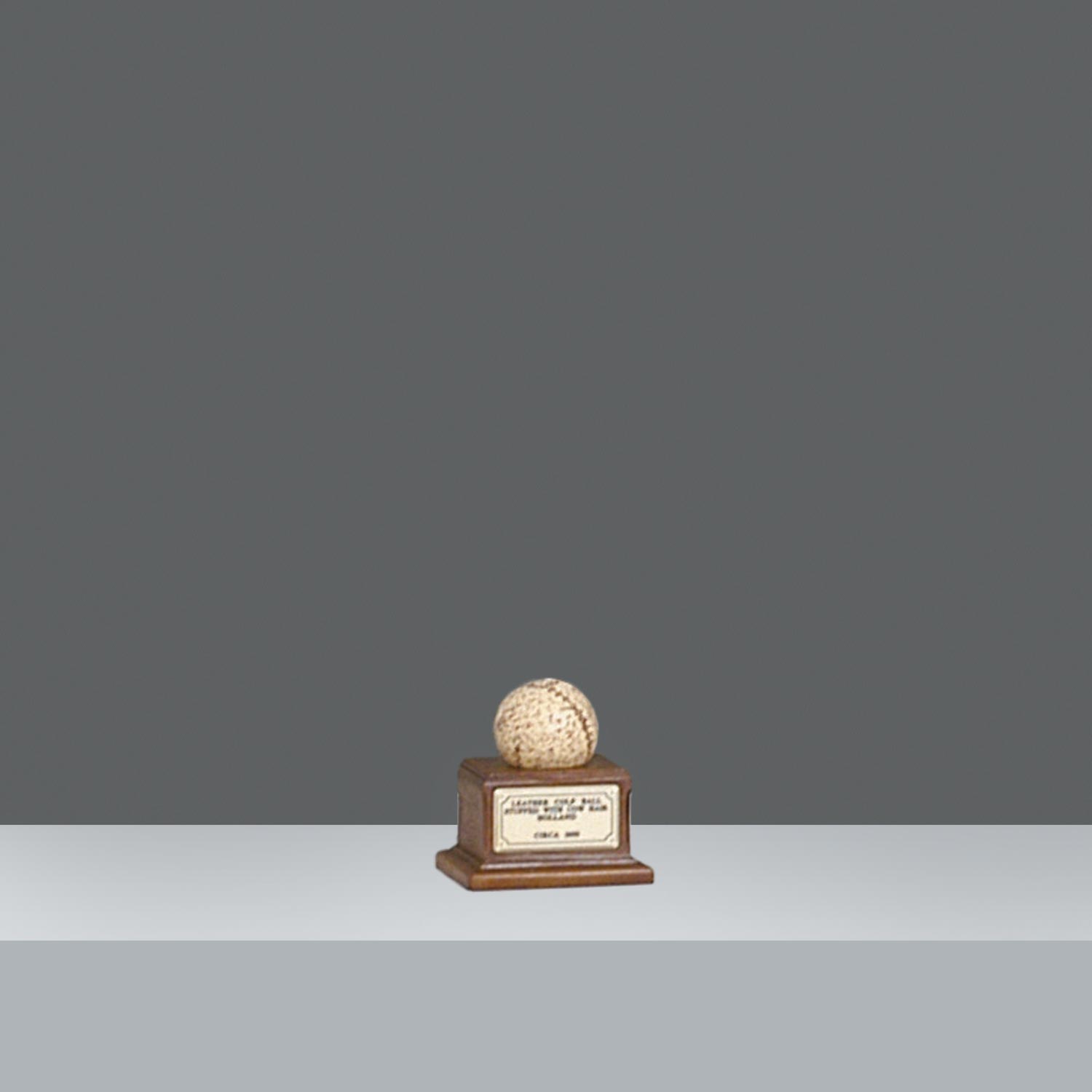 COLF BALL ON PLINTH